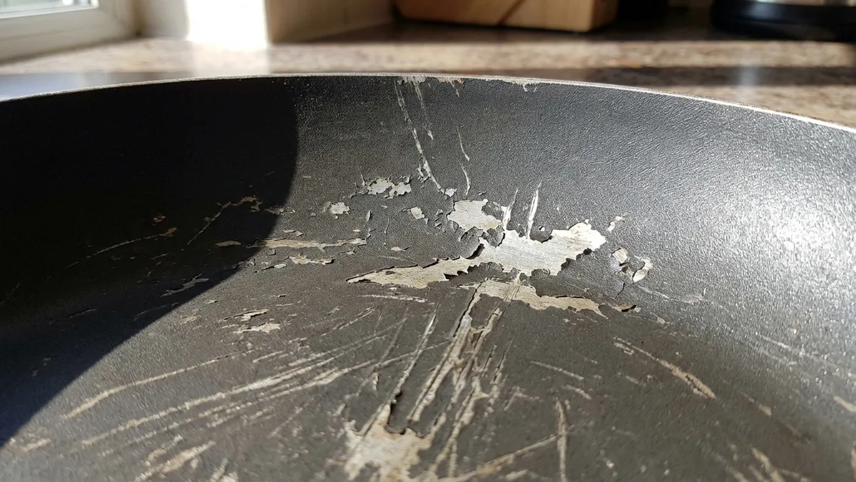 Close-up of a nonstick coated frying pan on a gas stove burner